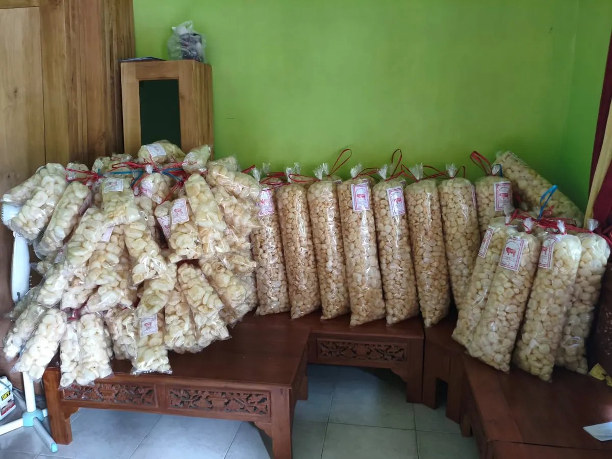 Kemasan kerupuk kulit sapi tersusun di kursi kayu